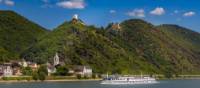 MS Olympia sails past a castle