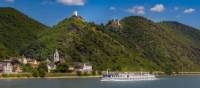 MS Olympia sails past a castle