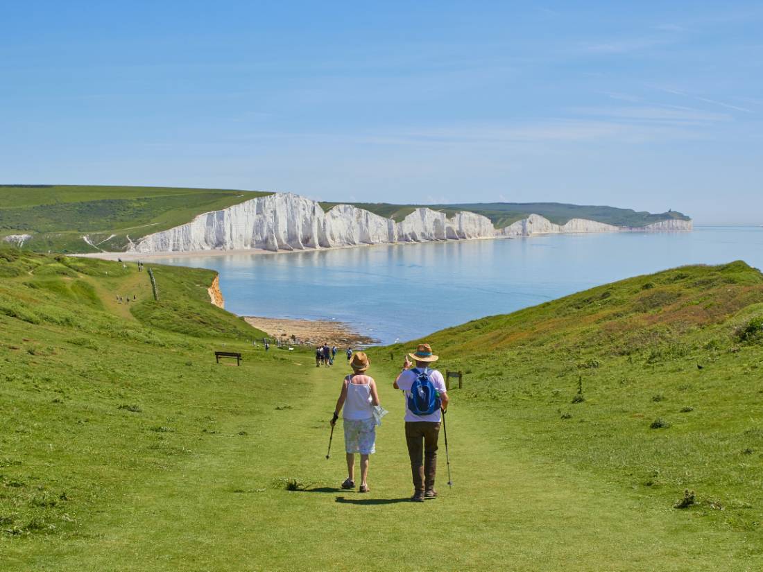 A couple walking towards the Seven Sisters on the South Downs Way |  Marc Najera