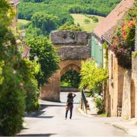 Old street of Domme village in Dordogne department, France