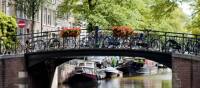 Bikes line the bridge over a canal in Amsterdam