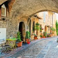 Charming arched street in the medieval town of Assisi