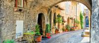 Charming arched street in the medieval town of Assisi