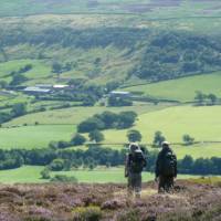 A couple enjoying the beautiful scenery on Wainwright's Coast to Coast |  John Millen