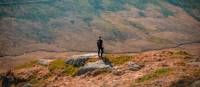 Hiker on a lush hillside in Snowdonia National Park
 | Zoltan Fekeshazy