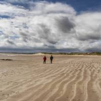 Walkers on Beadnell Bay Sands, Northumberland Coastal Path | Gordon Bell