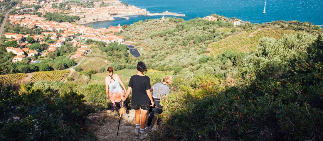 Hiking in the Eastern Pyrenees. Walk in the hills of Collioure. Holidays in the South of France. Walk with wind. Mediterranean panorama. Women hiking |  David Bise